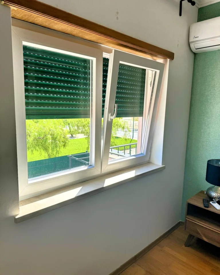 Janela em PVC branco com estore de lâminas, vista do interior